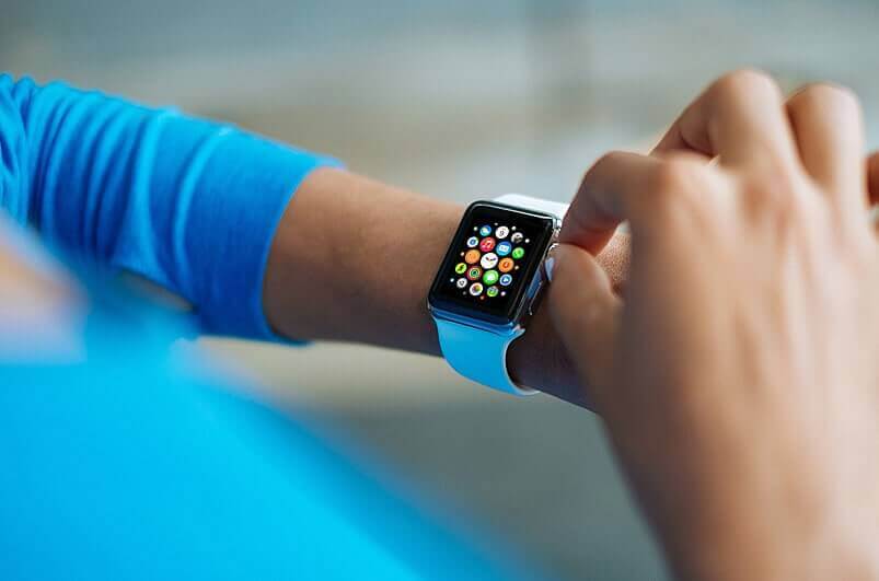 Smartwatch with colorful apps on wrist, enhancing connectivity and productivity, only available at Elevate Your Organization's Culture and Performance With CEEK.