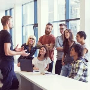 Team collaboration in a modern office setting, available at Elevate Your Organization's Culture and Performance With CEEK.