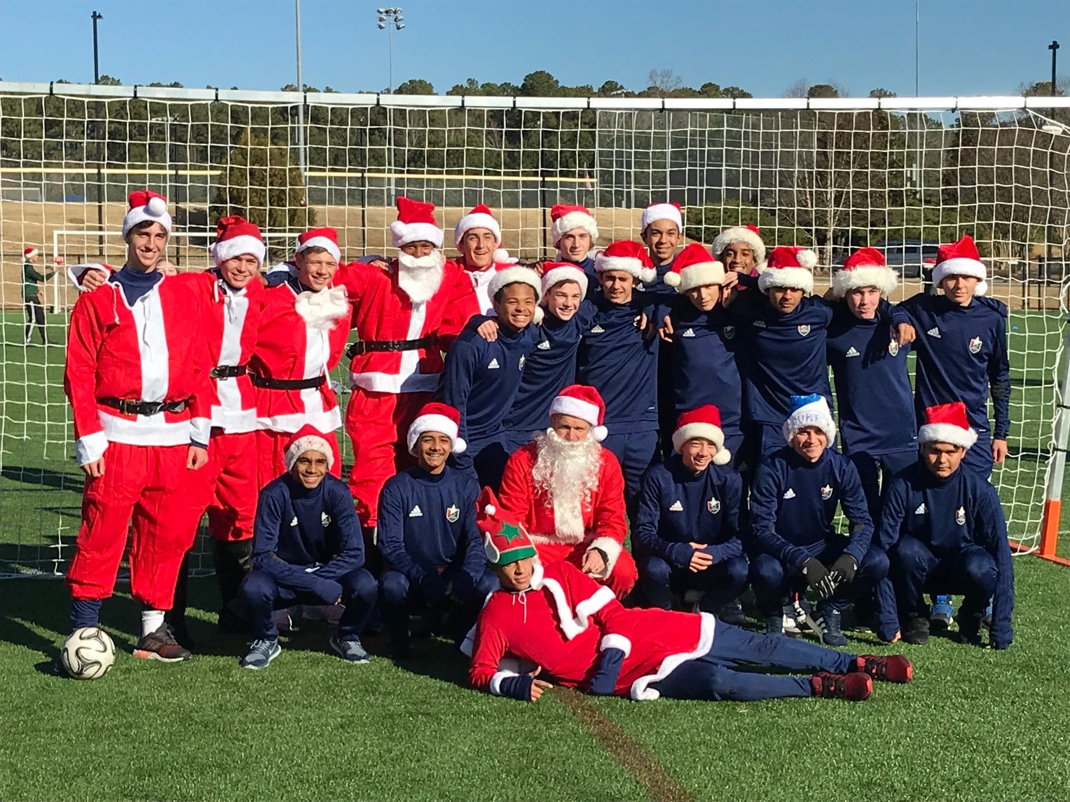 Soccer team in Santa outfits, celebrating on the field, enhancing culture at Elevate Your Organization's Culture and Performance With CEEK.