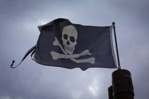 Skull and crossbones flag waving in the wind, symbolizing adventure, only available at Elevate Your Organization's Culture and Performance With CEEK.