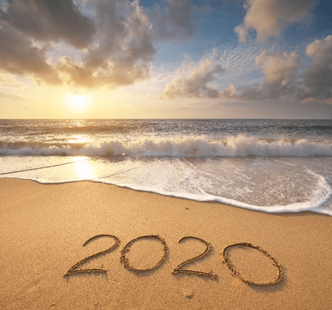 Beach sunset with '2020' written in sand, symbolizing new beginnings, only available at Elevate Your Organization's Culture and Performance With CEEK.