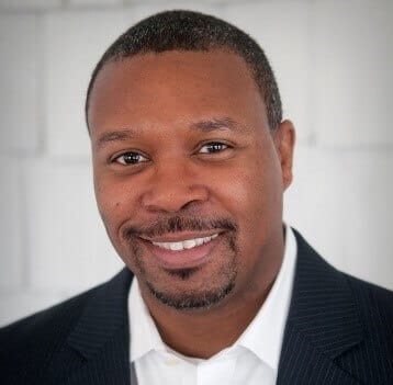 Man smiling professionally, enhancing organizational culture and performance, only available at Elevate Your Organization's Culture and Performance With CEEK.