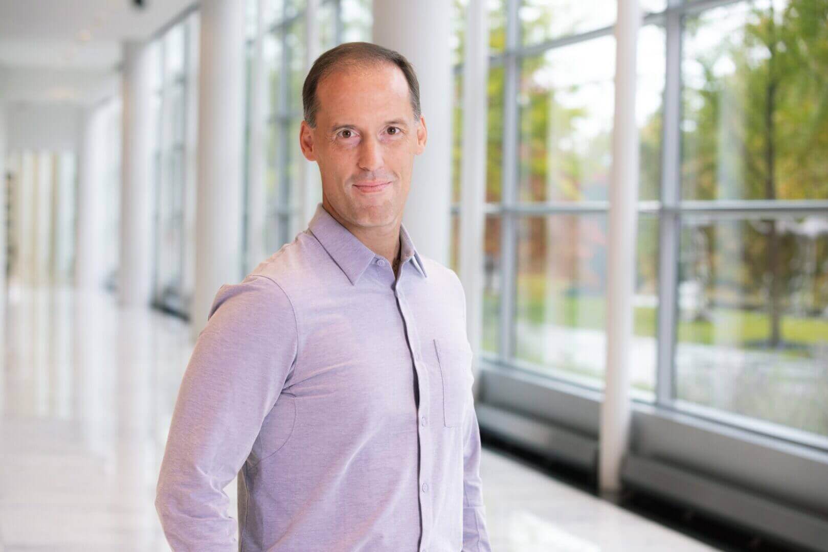 Professional man in a modern office setting, part of Elevate Your Organization's Culture and Performance With CEEK.