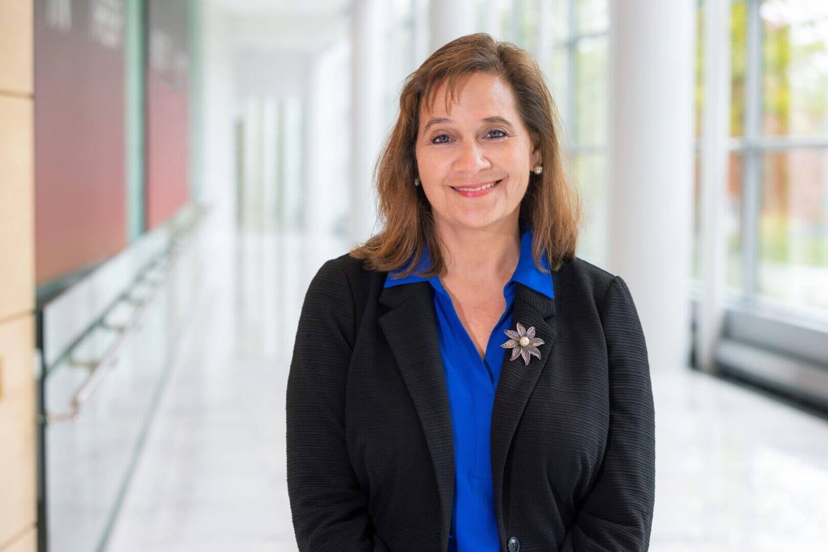 Professional woman in a corporate setting, embodying leadership and confidence, only available at Elevate Your Organization's Culture and Performance With CEEK.