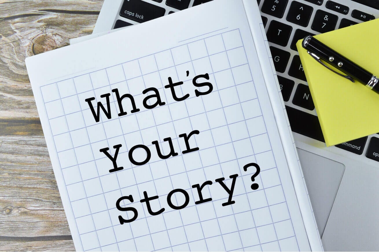 Notebook with 'What's Your Story?' text on a laptop, available at Elevate Your Organization's Culture and Performance With CEEK.