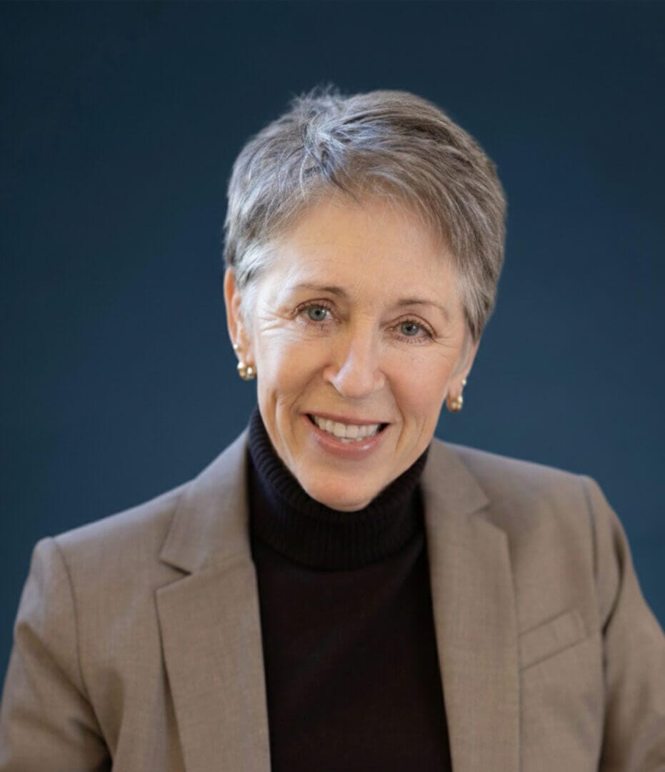 Professional portrait of a smiling woman in a blazer, available at Elevate Your Organization's Culture and Performance With CEEK.